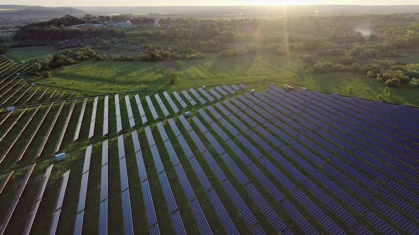 Ecology solar power station panels in the fields green energy at sunset alt