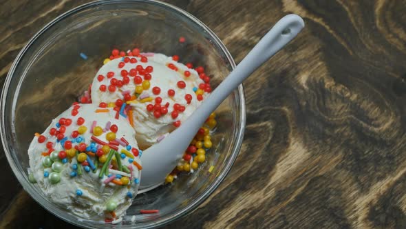Top View Closeup of White Ice Cream Balls Decorate with Colorful Decorations in a Glass Bowl with a