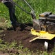 Unrecognizable Farmer Plow Arable Land with Rotary Gasoline Mini Tiller Slowmo - VideoHive Item for Sale
