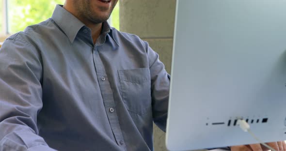 Male executive working on computer at desk 4k alt