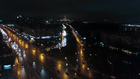 An Aerial Night View of a Busy Road Against the Endless Urbanscape alt
