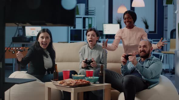 Happy Coworkers Playing Video Games After Work at Office alt