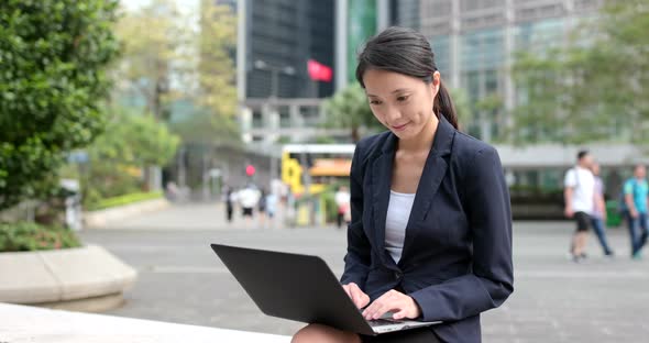 Business woman use of notebook computer at outdoor alt