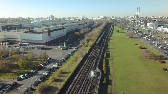 An Aerial View of an Industrial Urban Area with Railways, Parking Lots and Busy Traffic alt