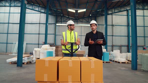 Factory Workers Deliver Boxes Package on a Pushing Trolley in the Warehouse alt