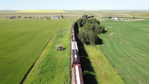 Aerial Footage Closely Flying Length Of Sitting Train Cars 