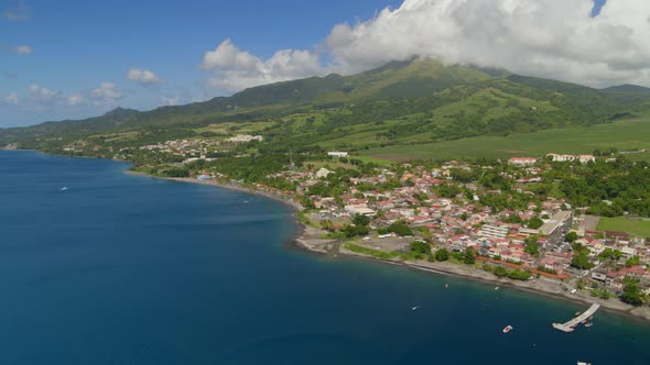 Aerial of beautiful green mountain and houses near Caribbean Coast alt