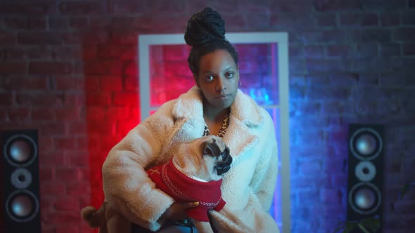 Portrait of African Woman Model in Stylish Clothes Posing on Camera with Cute Dog alt