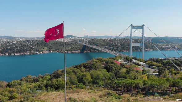 Aerial view of Fatih Sultan Mehmet Bridge and Turkish Flag alt