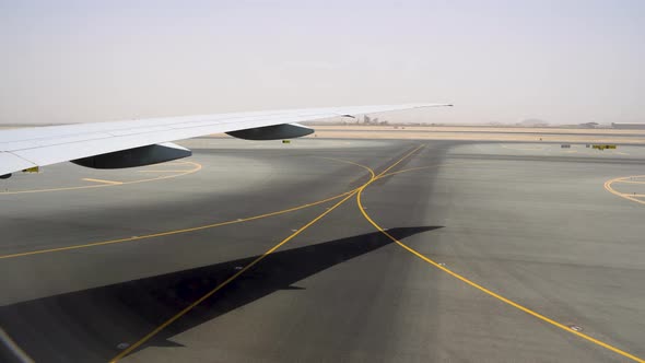 Wide area for take-off and landing strips. Runway covered with yellow markings alt