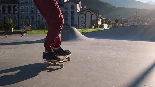 Professional Skateboarder Jumping Over the Obstacle in Skatepark alt