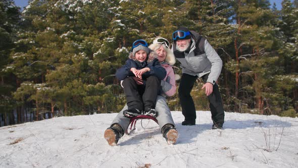 Fun Holidays Cute Male Child Will Spend Time with Caring Grandma and Grandpa Sledding in Snowy