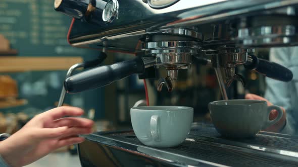 Making a cup of strong coffee in a coffee machine, the back light illuminates the steam and the cup. alt