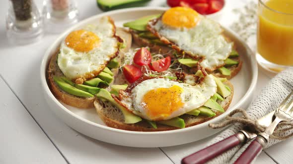 Delicious Healthy Breakfast with Sliced Avocado Sandwiches with Fried Egg alt