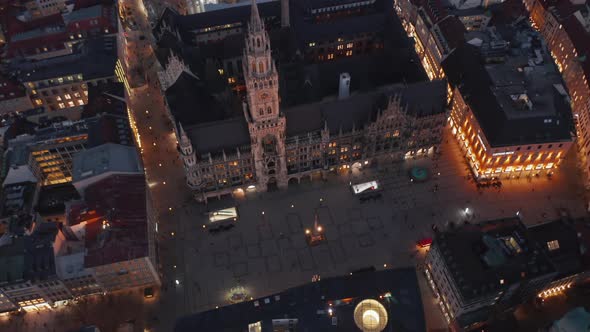 Tilt Down Revealing Famous Marienplatz in Munich, Germany at Night From Aerial Perspective alt