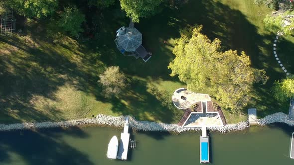 Lake Shore Top Down Drone Shot with Green Water and Boats