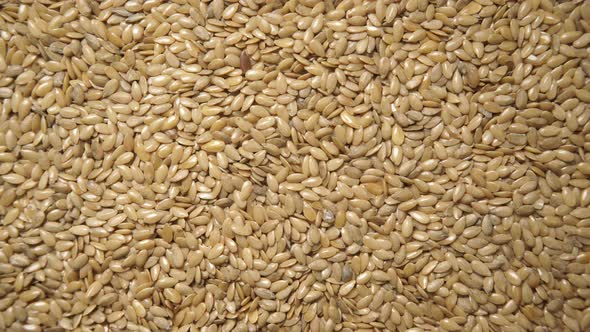 Golden Raw Flaxseeds as Background alt