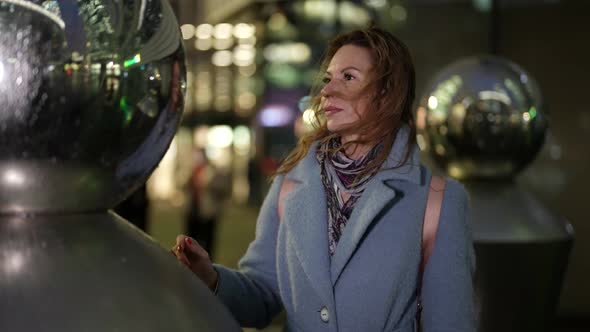 Passerby Woman in Modern City Street with Contemporary Art Sculpture Medium Portrait alt