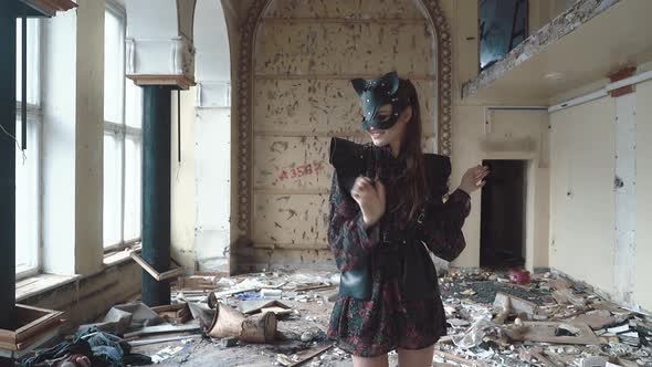 Young Beautiful Girl Stands on a Drum Among the Garbage alt