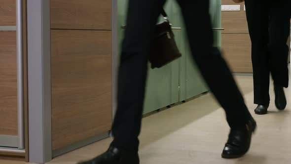 Male And Female Legs, People Walking At Office alt