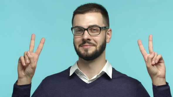 Slow Motion of Friendly Handsome Man in Glasses Smiling Showing Peace or Victory Gesture and Looking