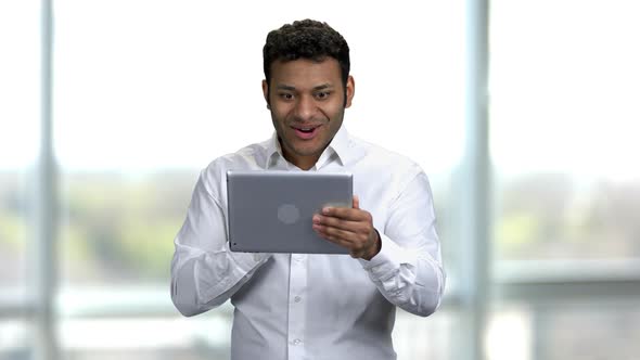 Portrait of a Emotional Positive Young Indian Man with Tablet Pc alt