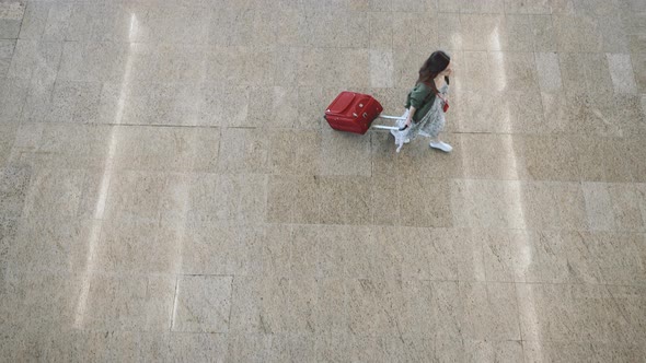 Young passenger with a suitcase at the airport  alt
