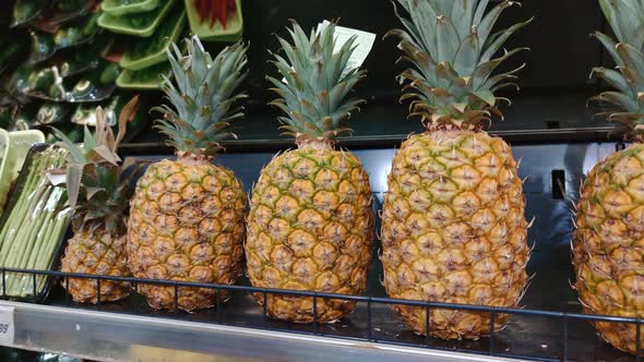 Faceless Woman Chooses Pineapple in Store Takes It alt