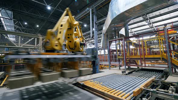 Factory Equipment Transporting Bricks. Automatic Robot Manipulator in Factory. alt