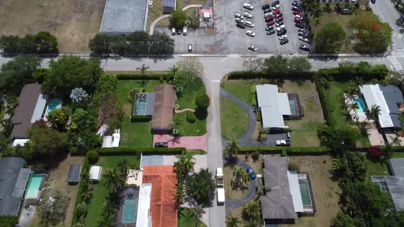 Aerial Tilt Reveal of a Rich South Florida Neighborhood with many Outdoor Pools alt