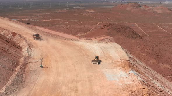 Large Industry Business Site, USA. Drone View on a Dumper Truck on a Dusty Road alt
