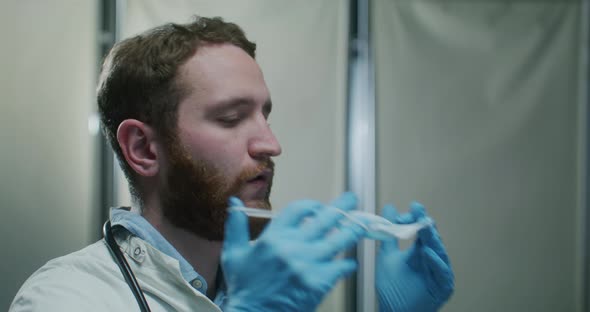 Portrait of Doctor Putting on a Protective Mask Incorrectly and Then Correctly