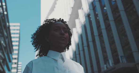 Attractive black business woman walking alt