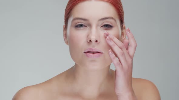 Studio portrait of young, beautiful and natural redhead woman. Beauty concept. alt
