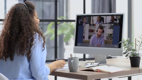 Attractive Woman Talking to Her Colleagues in Video Conference