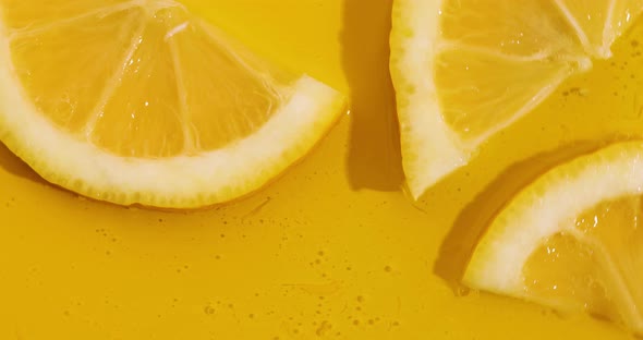 Top view rotation of fresh slice of lemons juice and gel serum