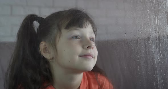 Looking out of window on rainy day.  alt