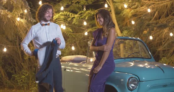 Elegant Loving Man Giving Jacket To Stylish Beautiful Woman in Summer Evening. Graceful Caucasian alt