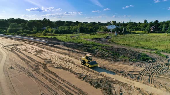 Aerial view of roller that compacts high spots down until soil is smooth alt