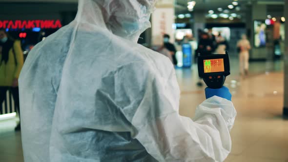 Medical Worker Is Scanning a Public Place with a Thermal Camera alt