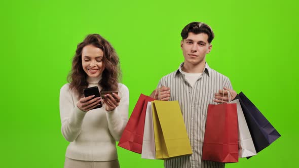 A Man is Holding Shopping Bags alt