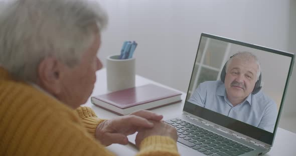 Middle-aged Man Is Communicating with His Elderly Father By Online Video Call on Laptop, Staying alt