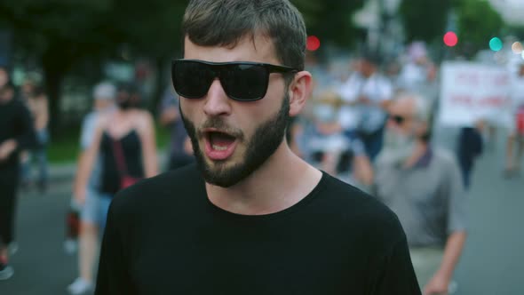 Shouting, screaming activist demonstrator on city street political riot, rally. alt