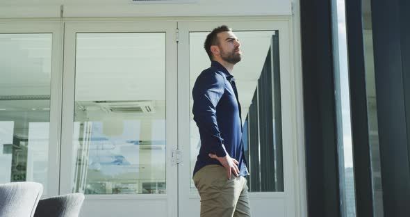 Business man thoughtful looking through the window alt