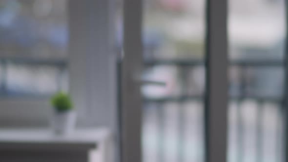 Window with an Open Door Traffic and People Outside the Window Blurred Background Defocus alt