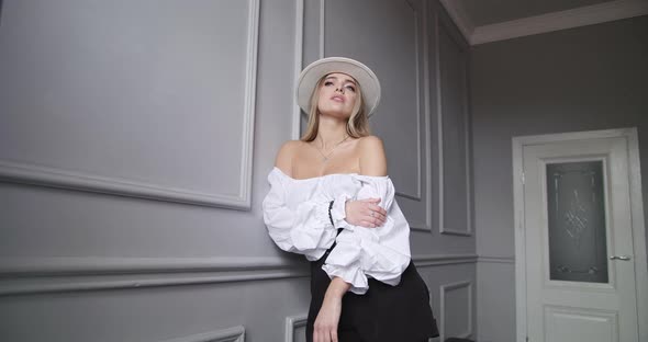 Young Woman Posing in a Hat Enchanting Look alt