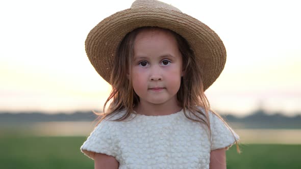 Portrait of Happy Little Girl in Straw Hat Smiling Closeup alt