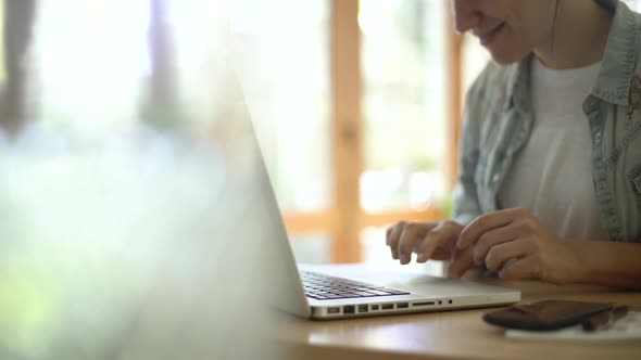 Woman using laptop at home alt