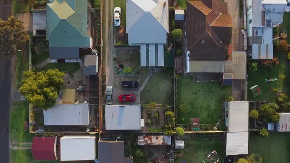 Drone aerial view top down of houses in small rural town Maffra, Victoria Australia. Sunset golden h alt