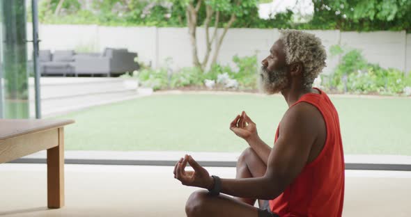 Video of african american senior man meditating alt